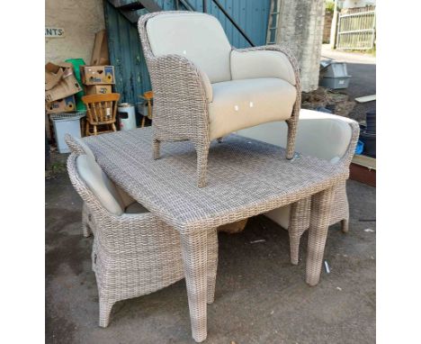 A modern Domus Ventures woven grey garden suite comprising three chairs, a bench and a table