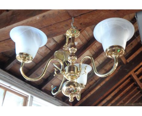 A brass three branch ceiling light with opaque glass shades