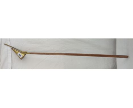 A long reach candle lighter and snuffer with brass terminal on a wooden shaft
