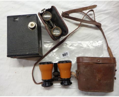 An antique pair of leather cad collapsable opera glasses, Kodak No2 Brownie camera and a pair of field glasses in leather cas