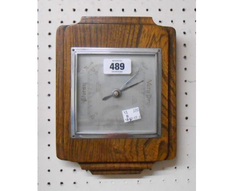 A vintage Shortland Bros wall barometer with aneroid works, set on stained elm backboard
