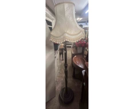 A vintage stained wood standard lamp with turned and reeded pillar, set on circular base - with shade - sold with an upholste