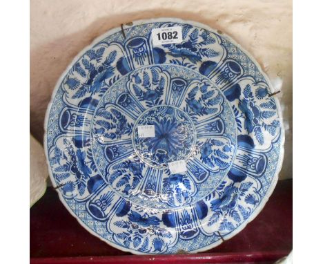 An 18th Century delftware plate with blue painted floral panel decoration