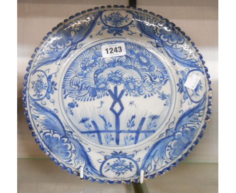 An 18th Century delftware plate with blue painted floral decoration