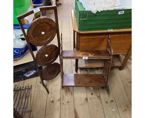 A small stained wood wall mounted two shelf unit with decorative pierced sides - sold with a polished oak three tier folding 