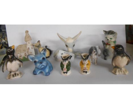 A quantity of small ceramic figurines including Wade Disney hatbox, Szeiler donkey, etc.
