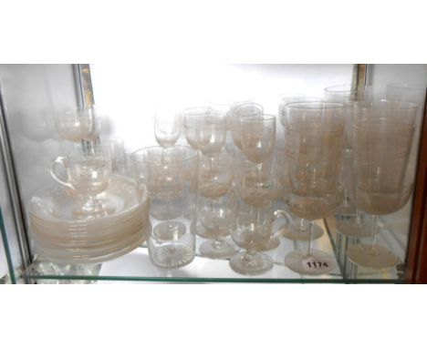 A large quantity of Edwardian table glassware with wheel cut decoration including champagne coupes, wines, etc.