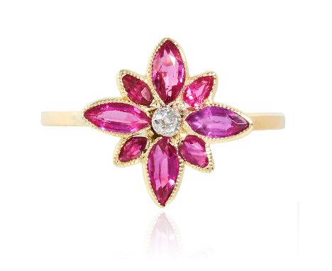 A RUBY AND DIAMOND RING in high carat yellow gold, set with a floral cluster of rubies and diamonds, unmarked, size N / 7, 1.