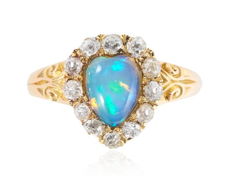 AN ANTIQUE OPAL AND DIAMOND CLUSTER RING, 19TH CENTURY in high carat yellow gold, the heart shaped cabochon opal encircled by