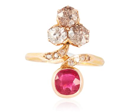 AN ANTIQUE RUBY AND DIAMOND DRESS RING in high carat yellow gold, the crossover design with a round cut ruby of approximately