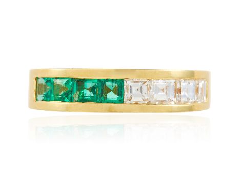 AN EMERALD AND DIAMOND HALF ETERNITY STACK RING in 18ct yellow gold, the squared band set with a row of four step cut diamond