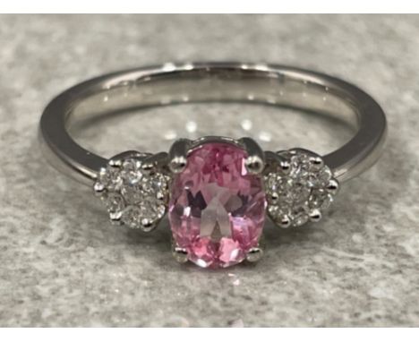 Ladies 9ct white gold Pink topaz and Diamond ring. Comprising of a Oval pink topaz set with 7 round brilliant cut diamonds on