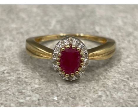 Ladies 9ct gold Ruby and Diamond cluster ring. Featuring a oval shaped Ruby surrounded by 14 round brilliant cut diamonds .50