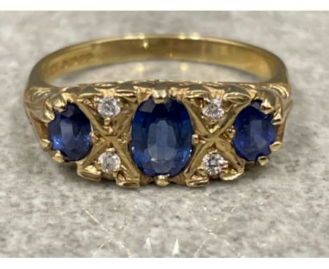 Ladies 9ct gold Sapphire and Diamond ring. Comprising of 3 oval shaped Sapphires with 2 round brilliant cut diamonds in betwe