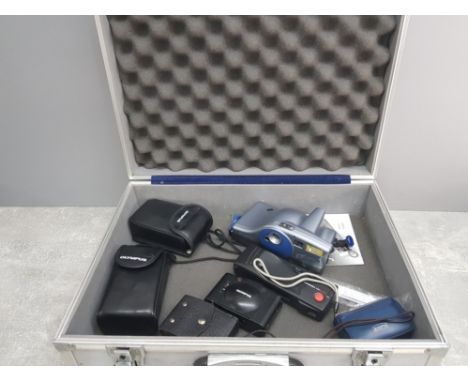Metal camera hardcase containing miscellaneous vintage cameras, including 3 by Olympus, Joycam, jenoptik