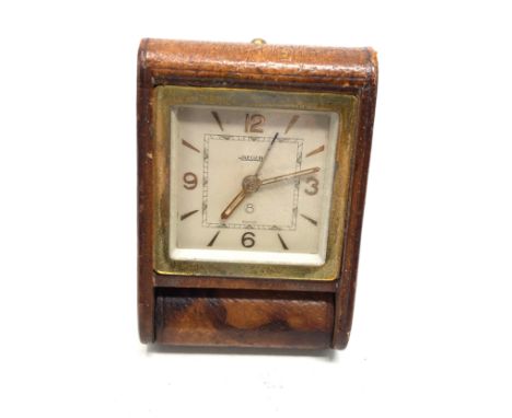 Vintage Jaeger 8 day travel clock brown leather case has wear as shown the clock winds and ticks 