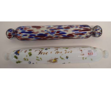 Two glass rolling pins, one with floral design with indistinct inscription, further pin with a streaked red and blue design (