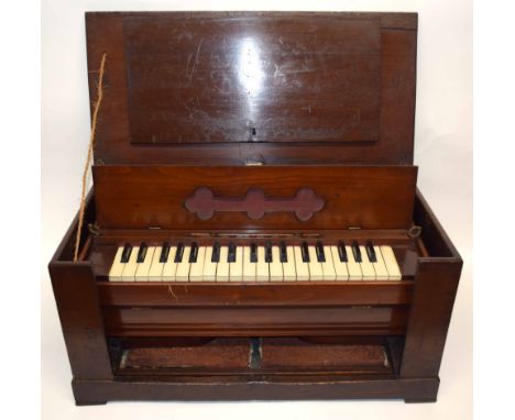 Small wooden travelling harmonium with keyboard and foot pedals in wooden frame