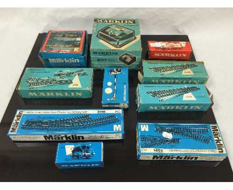 A quantity of Marklin model railway pieces including track, four carriages, signals, a transformer, etc., all parts boxed. (1