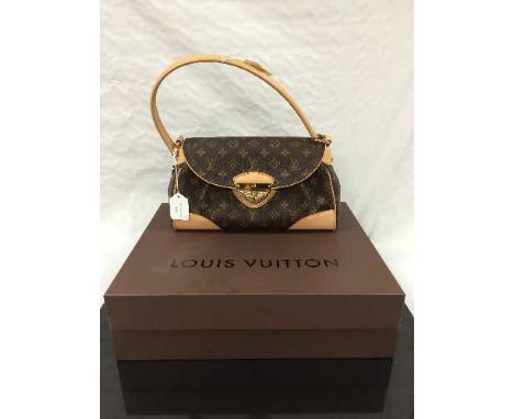 Louis Vuitton : A lady's Beverly hand bag, monogram canvas with tan trim, flap top secured with push lock closure, with carry