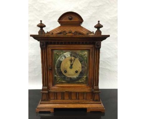 A Victorian walnut 8 day mantel clock, the brass dial with roman numerals with silvered chapter ring, the architectural case 