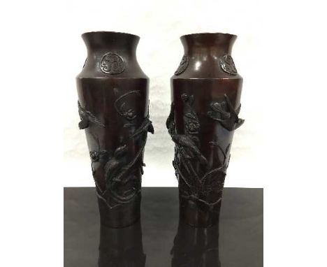 A pair of late nineteenth/early twentieth century Japanese bronze vases, the body cast with songbirds perching and in flight,