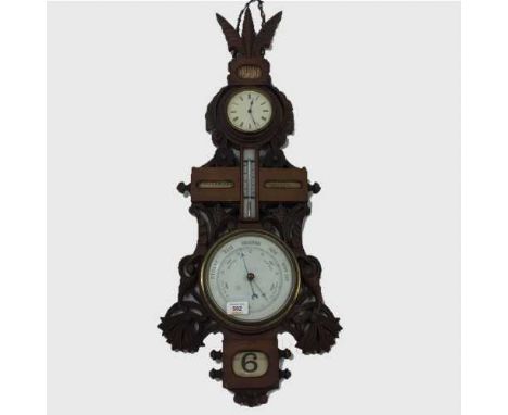 A carved oak combination wall clock/thermometer/barometer, circa 1900.