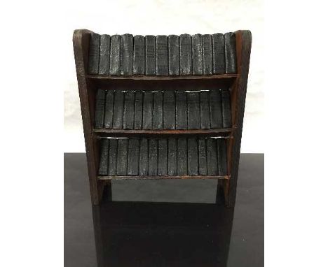 A late nineteenth/early twentieth century miniature oak bookshelf, holding 39 miniature novels, Shakespeare's works to includ
