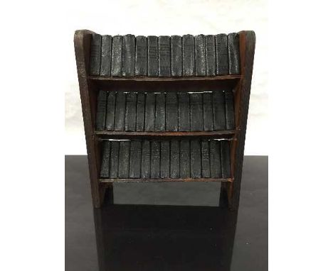 A late nineteenth/early twentieth century miniature oak bookshelf, holding 39 miniature novels, Shakespeare's works to includ