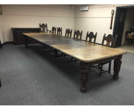 An extensive carved oak Victorian dining room suite, comprising of extending dining table, with 5 leaves, 451 cm length fully