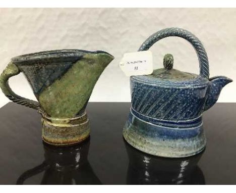 Jane Hamlyn (born 1940): A salt glaze teapot, in blue/green glaze, incised decoration, rope twist handle, impressed 'JH' sign