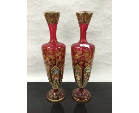 A pair of late Victorian Bohemian ruby glass vases, hand gilded and painted with floral decoration, height 41cm. CONDITION RE