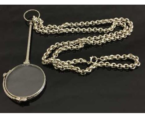 A white metal lorgnette suspended upon a Sterling silver belcher chain.