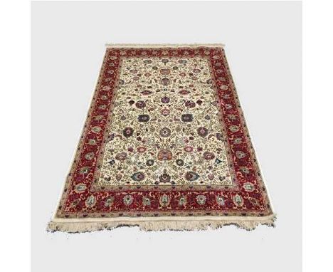 A silk finished Persian carpet on cream ground 154 cm x 226 cm.