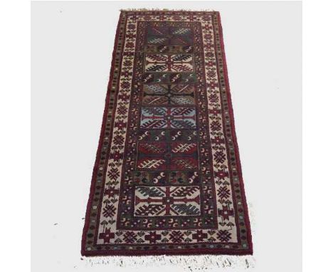 A fringed wool carpet runner on cream ground, 200 cm x 86 cm.