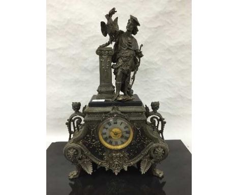 A Victorian spelter and marble 8 day mantel clock, surmounted by a huntsman holding foul and raised on paw feet, height 51cm.