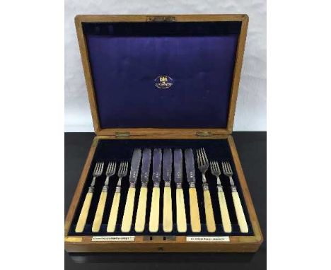 An oak cased canteen of silver cutlery, one fork associated, Sheffield 1909.