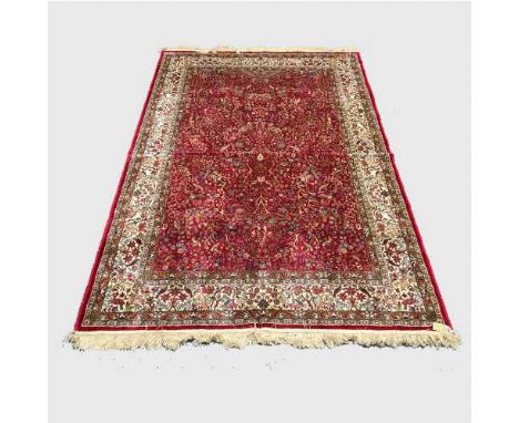 A silk finished Persian carpet on red ground, 155 cm x 227 cm.