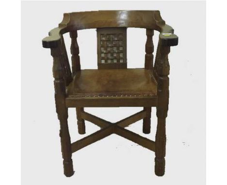 A carved oak armchair by Robert 'Mouseman' Thompson of Kilburn, width 62 cm. CONDITION REPORT: Structurally strong,no wobbles