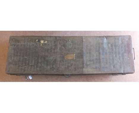 A tin trunk containing assorted uniforms