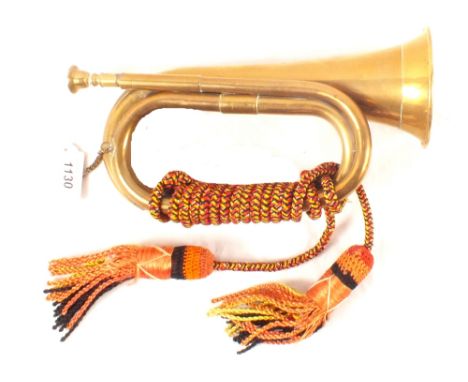 A brass bugle with lanyard