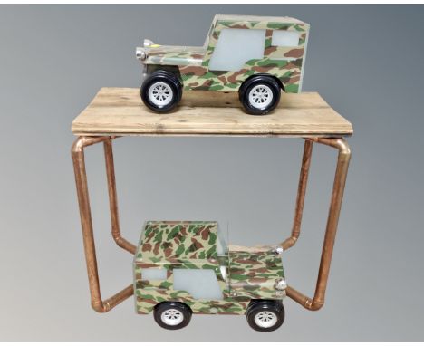 A pair of lights in the form of army jeeps together with a pine and copper pipe occasional table.