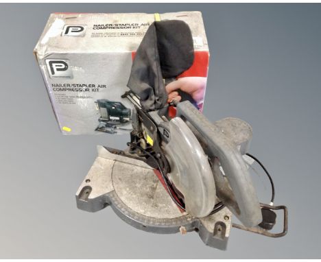 A nailer/stapler air compressor kit together with a 210mm compound mitre saw.