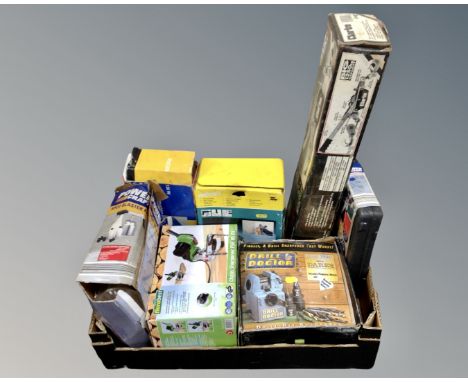 A box of boxed tools including Drill Doctor drill sharpener, Powercraft spot blaster, Clarke heavy duty power puller etc.