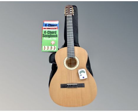 A Czech Strunal classical guitar in soft carry bag with guitar tuner and guitar books and accessories 