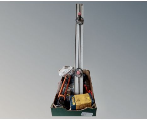 A box of tools including silicon gun, wire mesh.