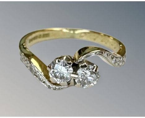 An antique 18ct yellow gold two stone diamond ring, with diamond shoulders, size J½, approximately 0.3ct of diamonds.