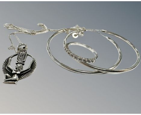 A sterling silver pendant on chain together with sterling silver dress ring and a pair of hoop earrings.