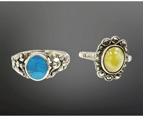A silver cluster ring and a silver and turquoise ring. (2)