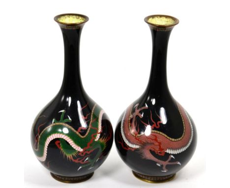 A pair of cloisonne enamel vases, decorated with trailing dragons on a black ground 